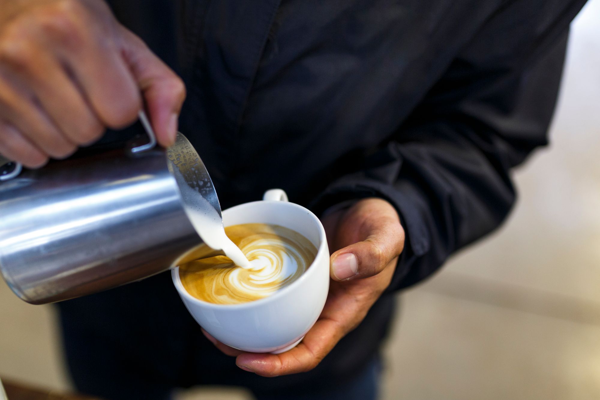 Barista gießt Latte Art